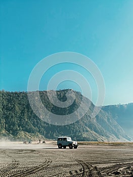 a jeep in the middle of the desert - Mount Bromo - Indonesia photo