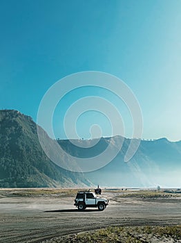 a jeep in the middle of the desert - Mount Bromo - Indonesia photo