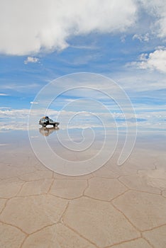 Jeep in the salt lake salar de uyuni, bolivia