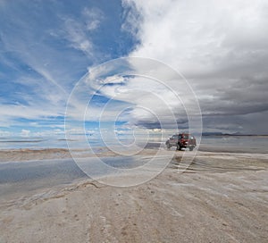 Jeep in the salt lake salar de uyuni, bolivia