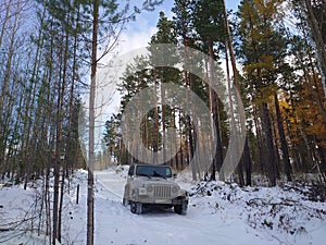 Jeep in the winter forest on a road