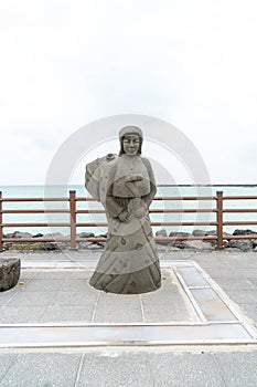 JEJU, KOREA - JULY 9, 2017: statue of Haenyeo at Hyeopjae Beach