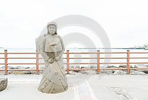 JEJU, KOREA - JULY 9, 2017: statue of Haenyeo at Hyeopjae Beach