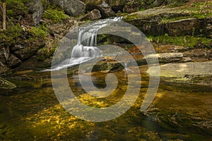 Jeleni waterfall in spring sunny cloudy day in Jizerske mountains