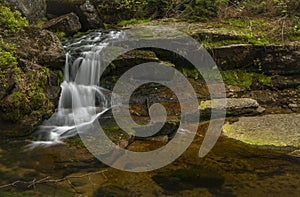 Jeleni waterfall in spring sunny cloudy day in Jizerske mountains