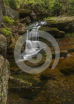 Jeleni waterfall in spring sunny cloudy day in Jizerske mountains photo