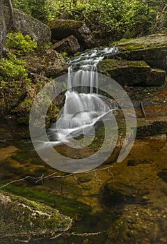 Jeleni waterfall in spring sunny cloudy day in Jizerske mountains photo