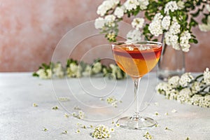 Jelly dessert. Elegant stemware glass of delicious fruit dessert in  on gray table surface surround of spirea blossom