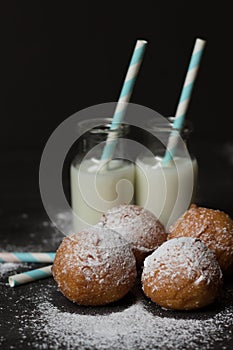 Jelly doughnuts and two bottles of milk