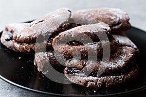 Jelly Filled Chocolate Cookies with Powdered Sugar and Cherry Jam.