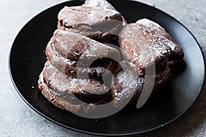 Jelly Filled Chocolate Cookies with Powdered Sugar and Cherry Jam.