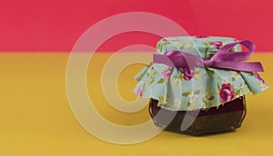 Jelly in on pot isolated on colored background. Fresh colors pastel trend photo
