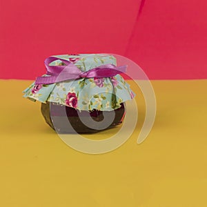 Jelly in on pot isolated on colored background. Fresh colors pastel trend photo