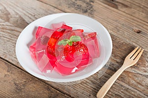 Jelly strawberry on white plate.