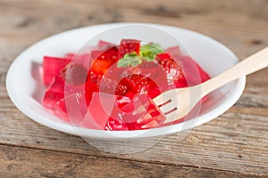 Jelly strawberry on white plate.