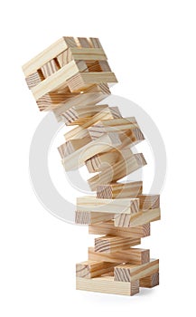 Jenga tower made of wooden blocks falling on white background photo