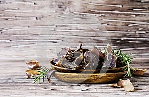 Jerked meat, cow, deer, wild beast or biltong in wooden bowls on a rustic table photo