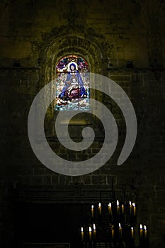 Jeronimos monastery dark interior seeing stained glass window