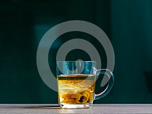 Jerusalem artichoke, herbal tea, dietary product, brewed infusion in a glass mug.