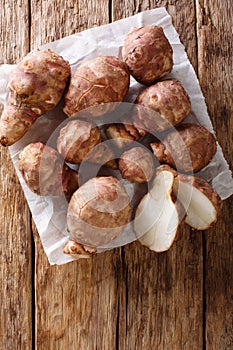 Jerusalem artichoke sunroot tubers. Helianthus tuberosus closeup on the table, Vertical top view