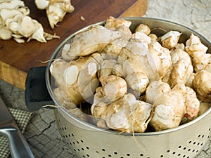 Jerusalem artichokes in a colander