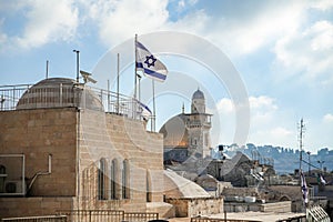 The Israeli flag against the backdrop of the Al Aksa mosque in the Jewish quarter in the old city of Jerusalem near the Western Wa
