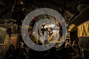 A group of believers holds a joint prayer in the Christmas Cave in the Church of Nativity in Bethlehem in Palestine