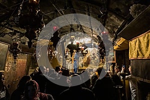 A group of believers holds a joint prayer in the Christmas Cave in the Church of Nativity in Bethlehem in Palestine