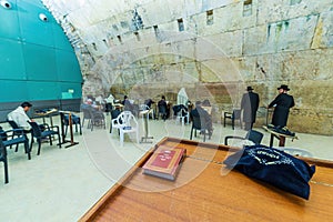 JERUSALEM, ISRAEL - JANUARY 14, 2020: Religious Jews pray by the Western Wall inside of the Western Wall Tunnel at the