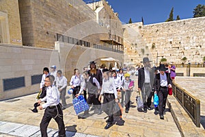 Jewish people praying against the Western Wall in Jerusalem