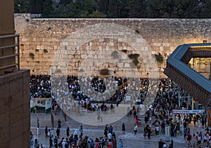 Numerous believers are in the evening near the Western Wall in the old city of Jerusalem for a holiday prayer dedicated to the hol