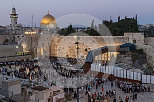 Numerous believers are in the evening near the Western Wall in the old city of Jerusalem for a holiday prayer dedicated to the hol