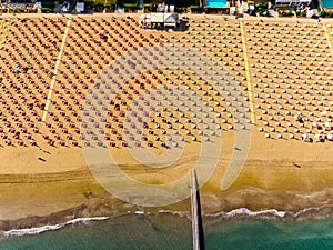 Jesolo - Golden Beach and umbrellas from above with sea and docks