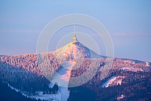 Jested Mountain and Jested Ski Resort in morning sunrise time. Clear sky and freezy winter time mood. Liberec, Czech