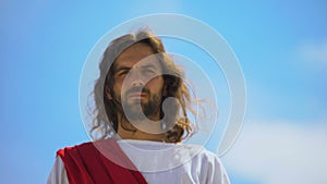 Jesus approaching to camera, looking with mercy, forgiving sins, bottom view