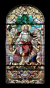 Jesus blesses mothers with children, stained glass window in the St John the Baptist church in Zagreb, Croatia photo