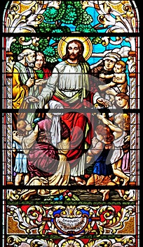 Jesus blesses mothers with children, stained glass window in the St John the Baptist church in Zagreb, Croatia photo