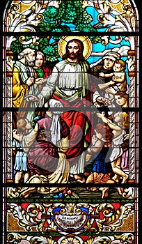 Jesus blesses mothers with children, stained glass window in the St John the Baptist church in Zagreb, Croatia photo