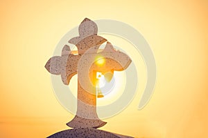 Jesus Christ cross. The Crucifixion, Resurrection and Easter concept. The Christian cross with a sunset scene in warm tone