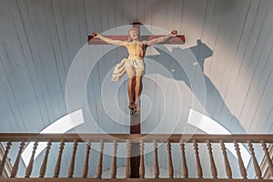 Jesus Christ on the cross with low angle view and magic light