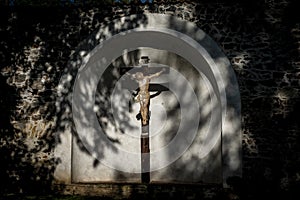 Jesus Christ on the cross in a niche of a white wall