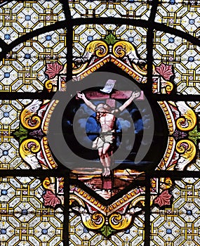 Jesus Christ on the cross, stained glass window in the Saint Sulpice Church, Paris