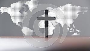Jesus christ cross on wooden table with world map blur background. Idea of mission evangelism and gospel on world. Copy space for photo
