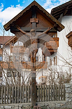 Jesus Christ crucified on wooden roadside cross, South Tyrol, Italy photo