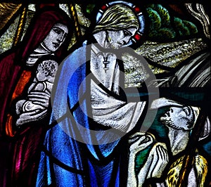 Jesus Christ curing a blind person in stained glass photo