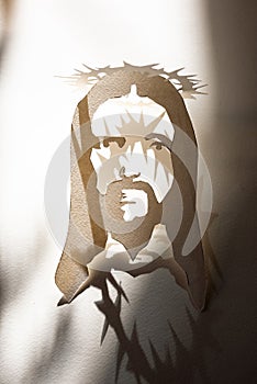 Jesus Christ face paper template and shadow with thorn crown as christian religion savior God
