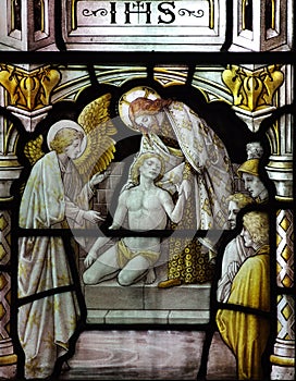 Jesus Christ helping a poor man (in stained glass)