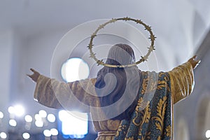 jesus christ with his back and open arms towards the light inside the Igreja Matriz de Colares Nossa Senhora da AssunÃ§Ã£o photo