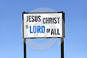 Jesus Christ is lord of all religious sign board post against blue sky