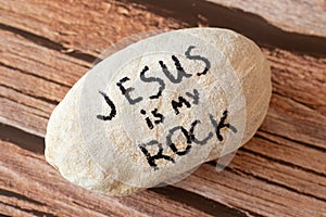 Jesus Christ is my God, Rock, Salvation, Savior, and Deliverer. A handwritten quote from Holy Bible on a stone. photo